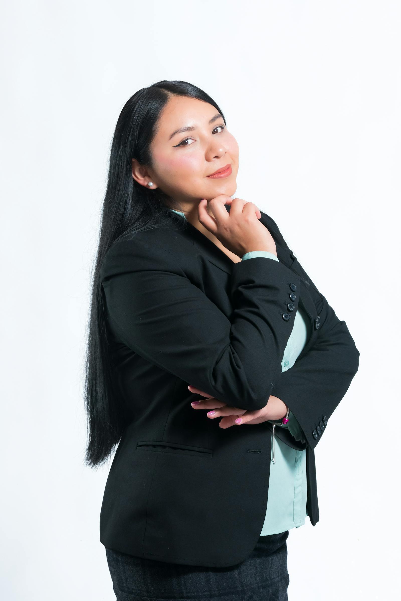 Studio portrait of Mira Charles, founder of Mira Beauty, in a navy linen overshirt.